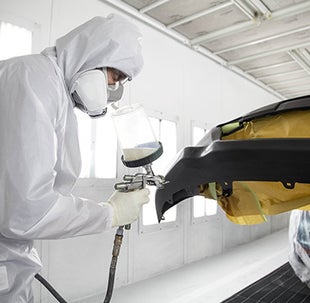 Collision Center Technician Painting a Vehicle | Toyota South Atlanta in Morrow GA